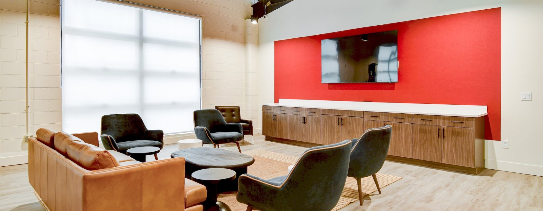 Room with furniture, tv, and red wall