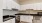 White apartment kitchen with stainless steel appliances