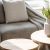 sunlight pours through a large window in furnished living room