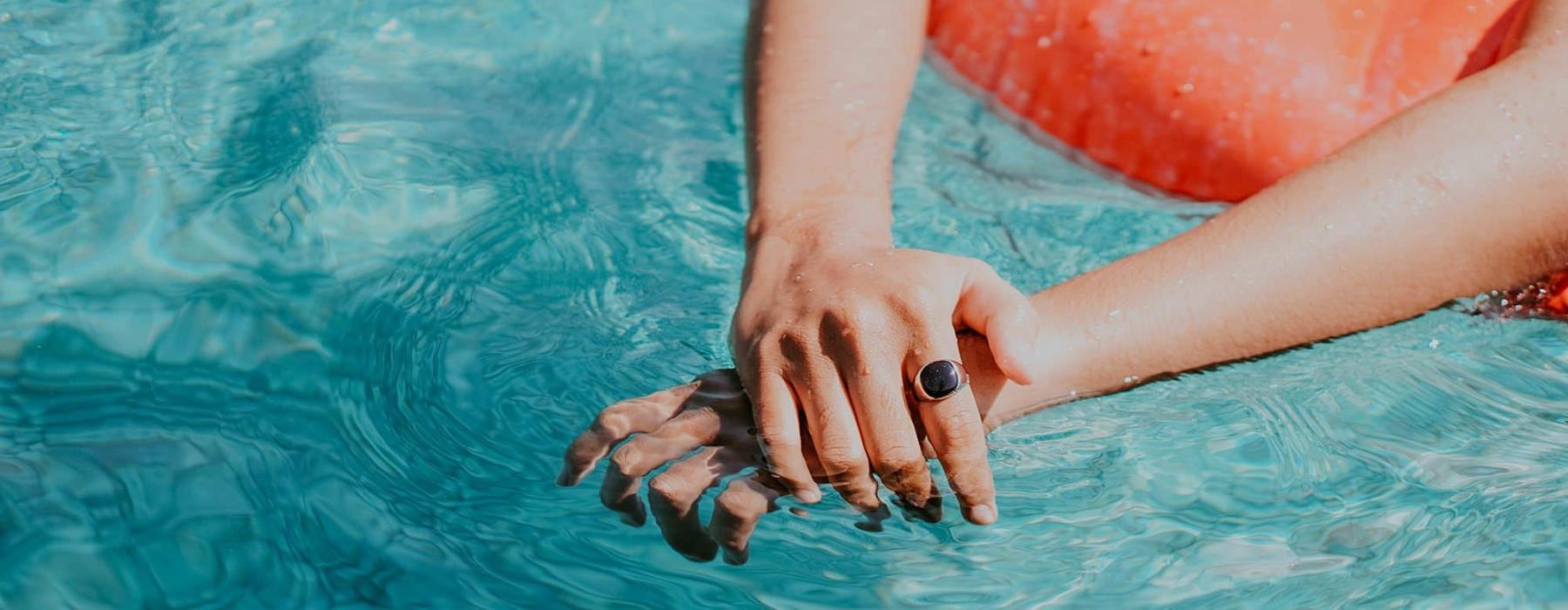 woman relaxes on a floatie in swimming pool